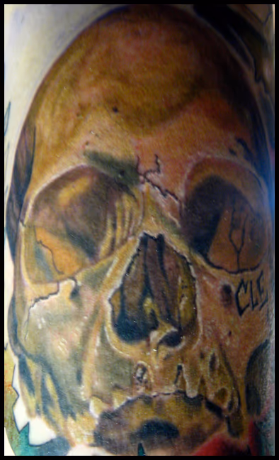 Here is a skull tattoo that I did on my friend Brandon before he move to Charlotte, NC. We carved CLE under the eye socket to represent our grimey hometown of Cleveland, Ohio. Good luck bro! color skull cleveland tattoo