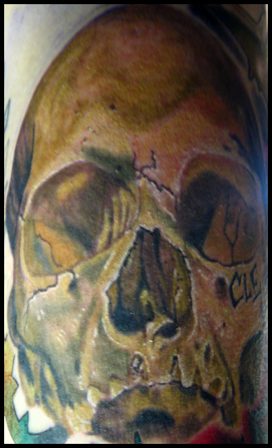 Here is a skull tattoo that I did on my friend Brandon before he move to Charlotte, NC. We carved CLE under the eye socket to represent our grimey hometown of Cleveland, Ohio. Good luck bro! color skull cleveland tattoo
