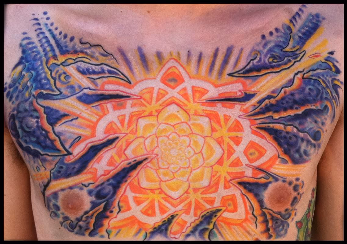 Mandala and bio organic chest tattoo