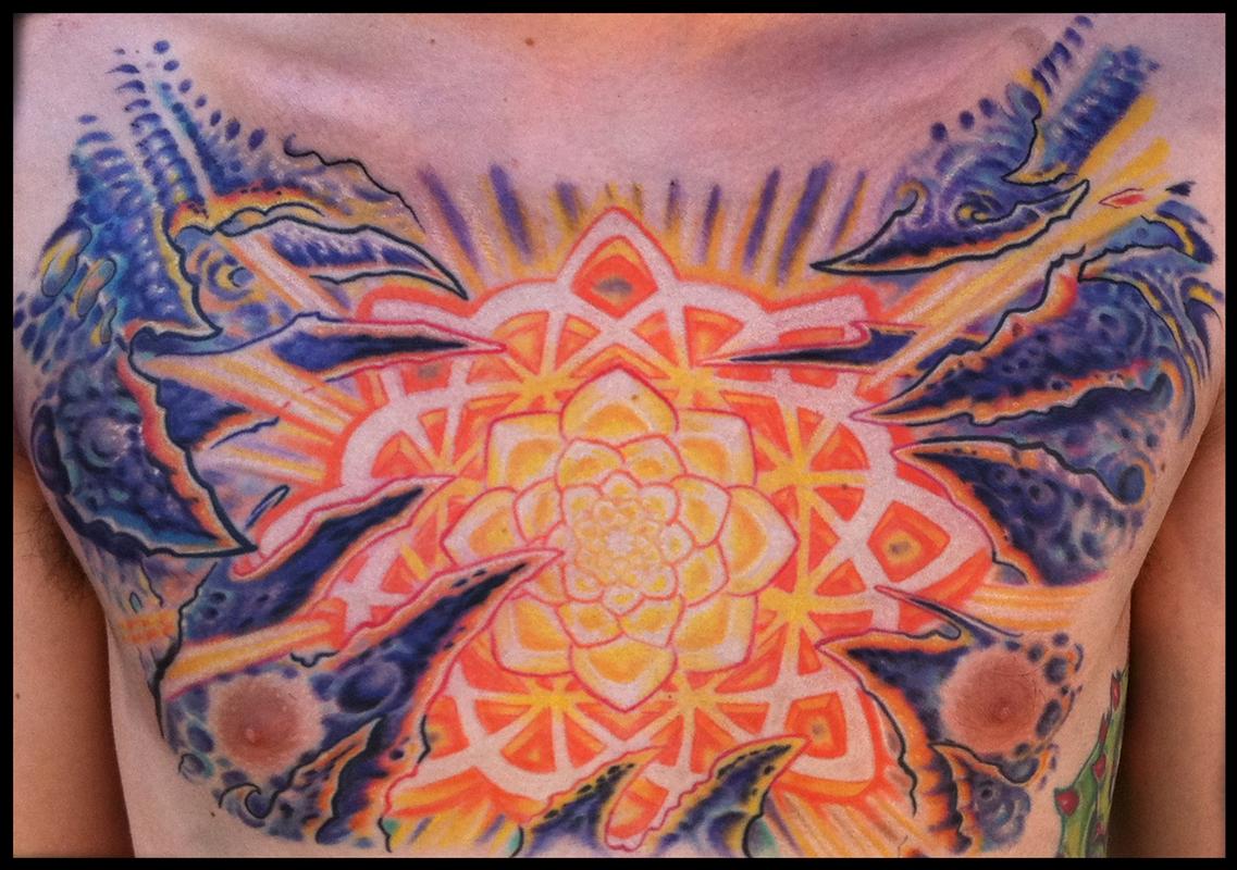 Mandala and bio organic chest tattoo