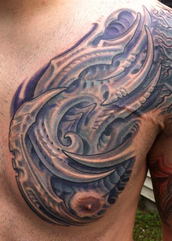 Bio mech chest tattoo