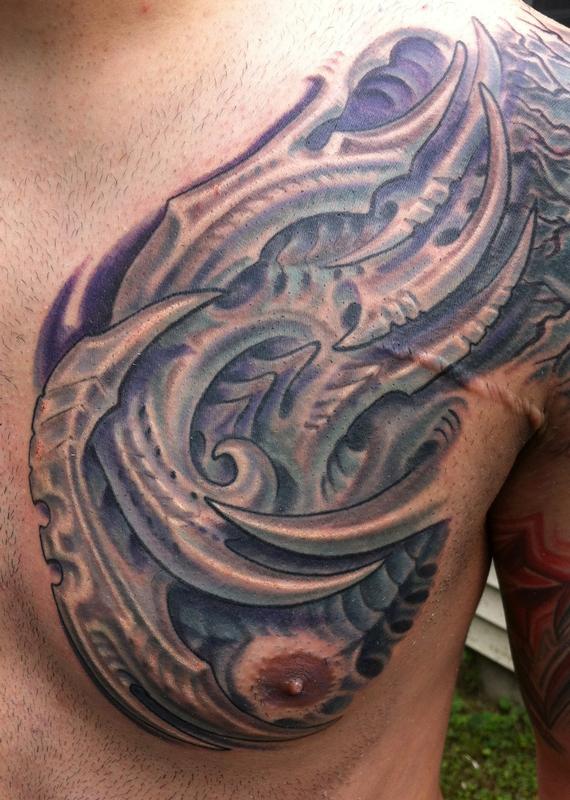Bio mech chest tattoo