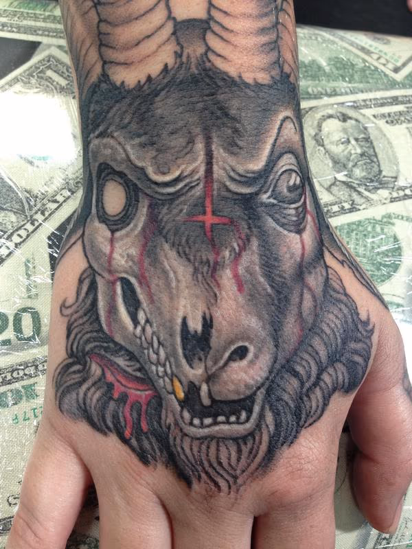 Evil decaying goat skull hand tattoo