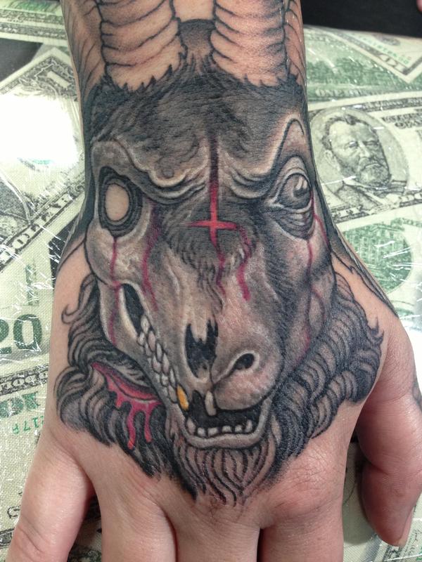 Evil decaying goat skull hand tattoo