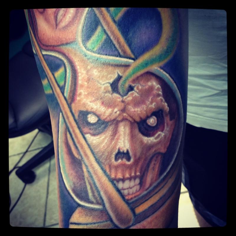 Skull in an hourglass tattoo close-up