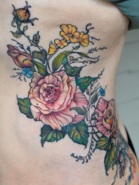 vintage rose flower rib tattoo