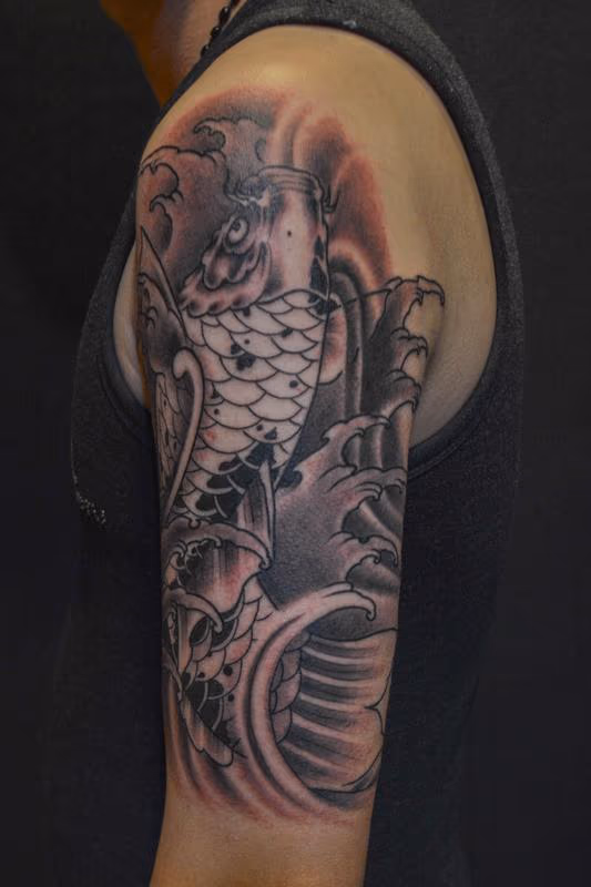 Black and Grey Koi Fish with Waves