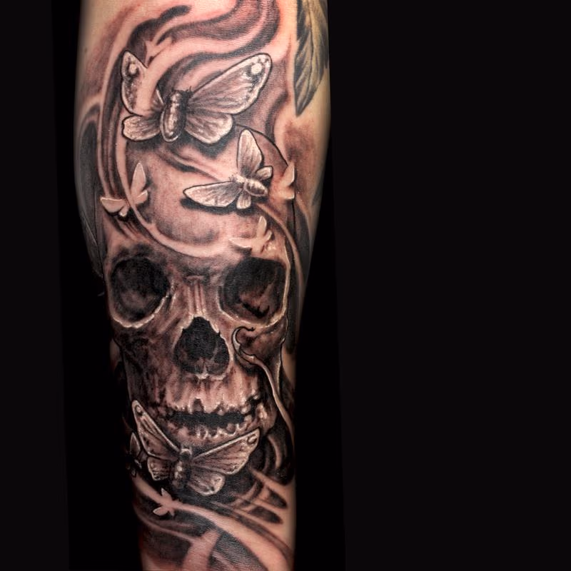 Skull and moths tattoo