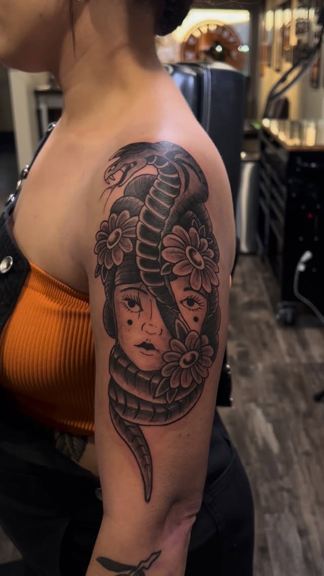 Black and grey snake and skull portrait, shoulder