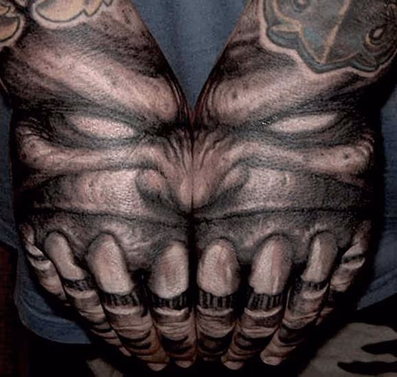 Demon with teeth hand tattoo