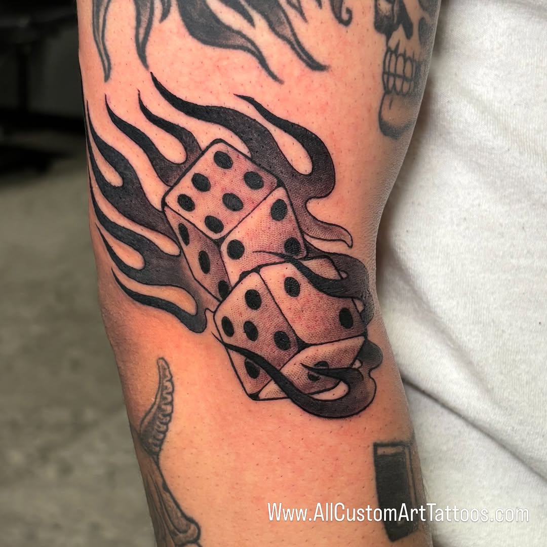Flaming dice tattoo in black-and-grey, knee