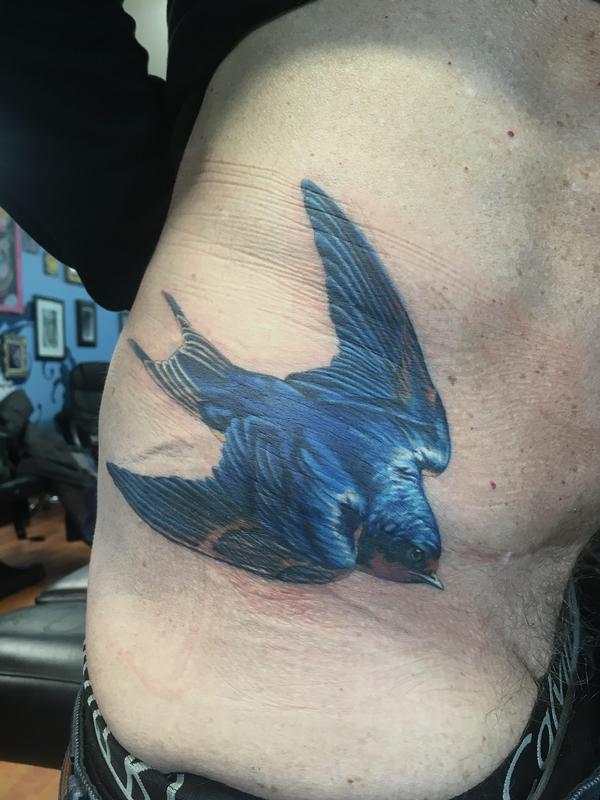 Realistic blue sparrow on hip