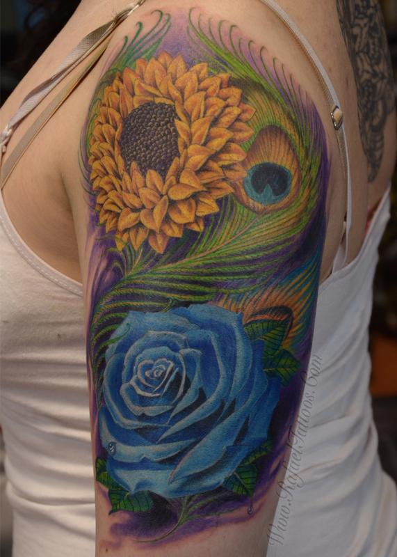 Full colored blue rose and sunflower with peacock feathers arm tattoo