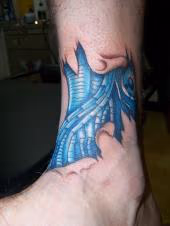 bio-mechanical skin rip tattoo