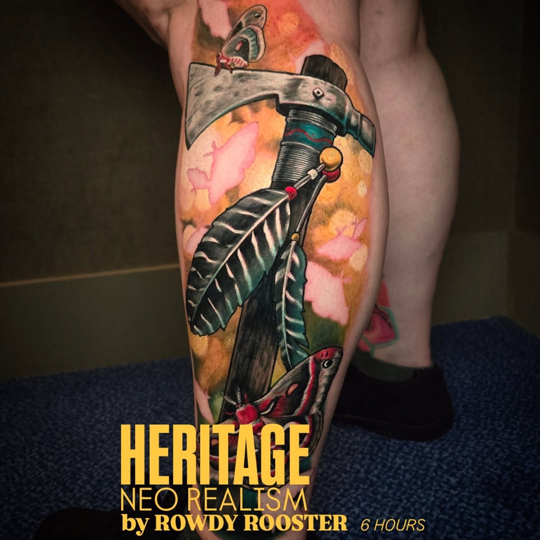 Native American heritage axe and feather calf tattoo