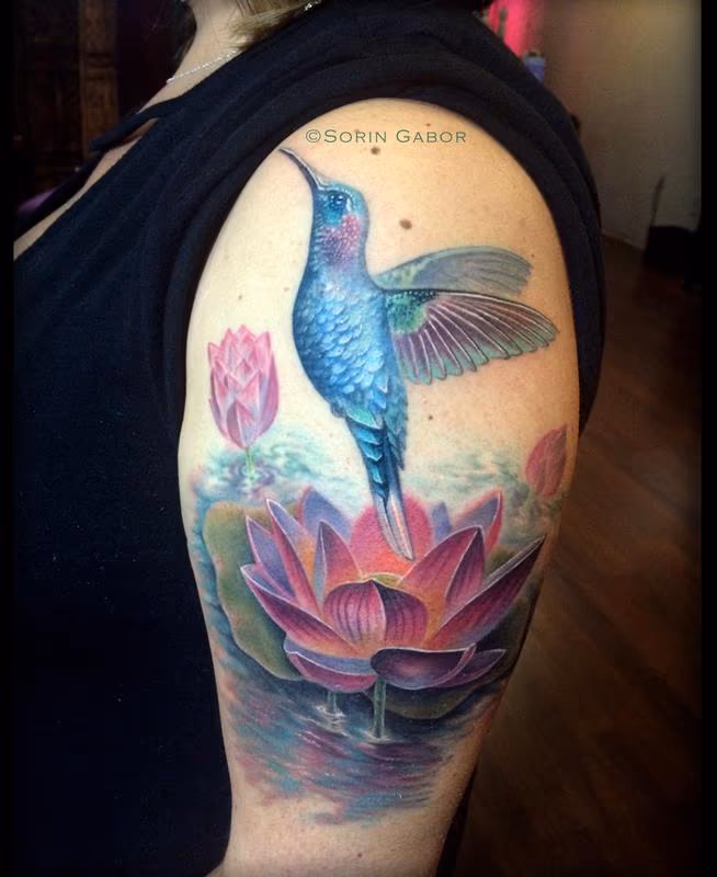 Humming bird flying out of lotus