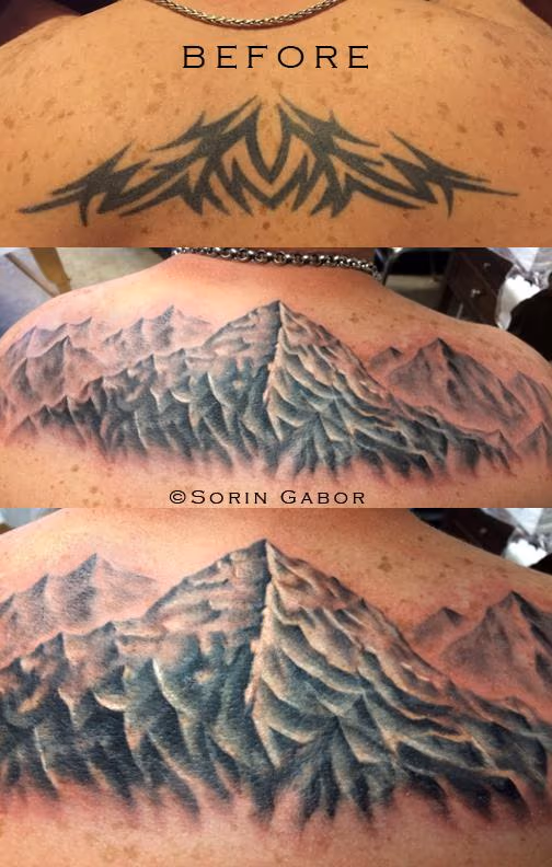Realistic black and gray mountains over a tribal coverup