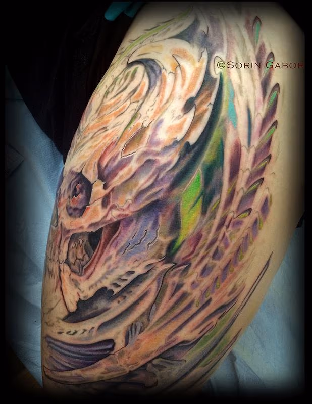 realistic color bio organic skull tattoo