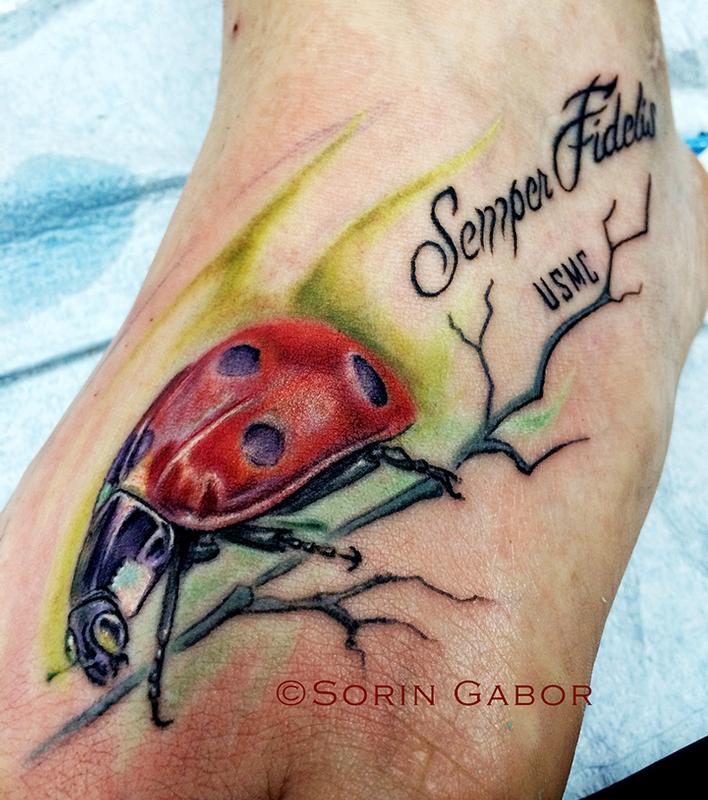 Realistic color ladybug foot tattoo