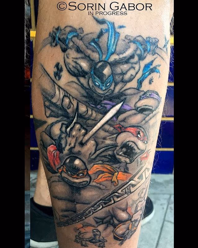 black and gray ninja turtles with color details tattoo