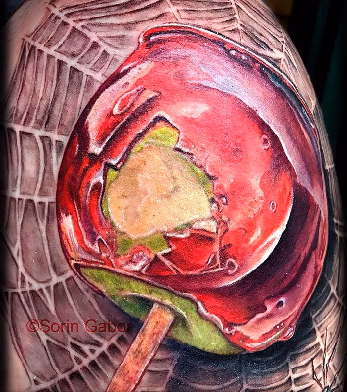 realistic color candy apple on spiderweb tattoo