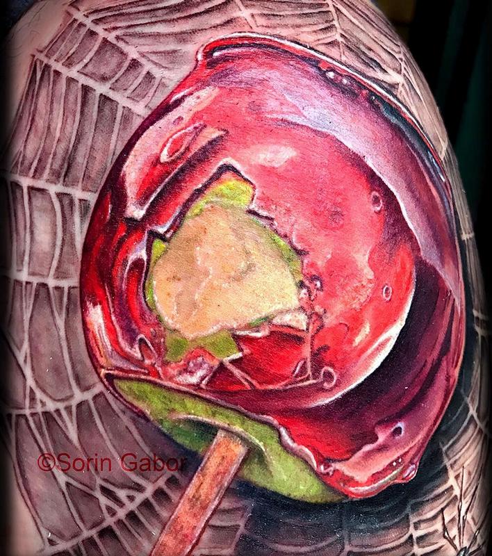 realistic color candy apple on spiderweb tattoo