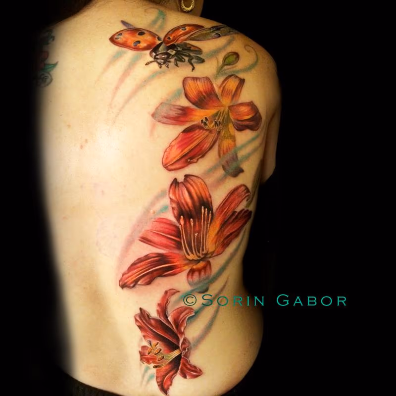 Realistic color feminine tattoo of lillies and flying ladybug