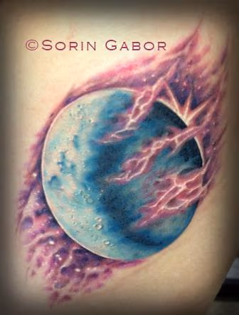 Realistic color moon and space tattoo on ribs