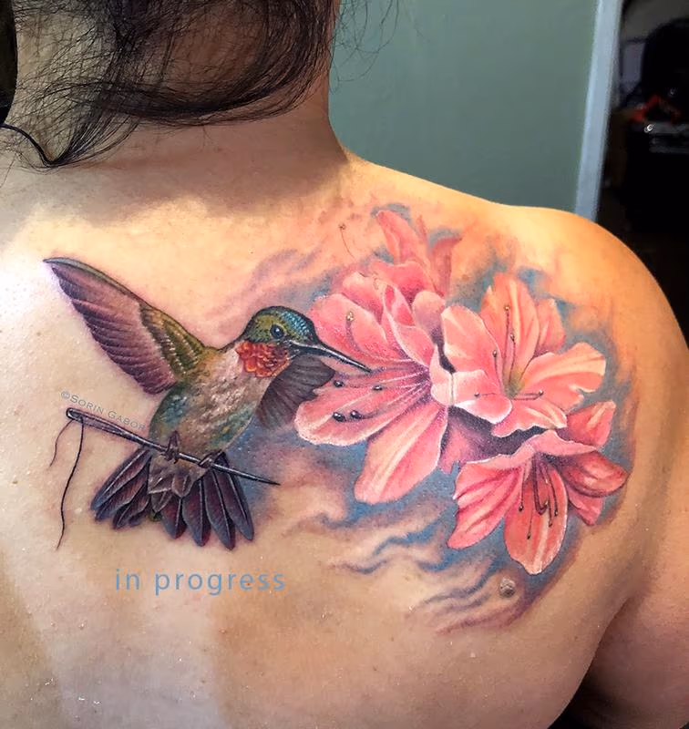Realistic color humming bird, flower, and sewing needle tattoo