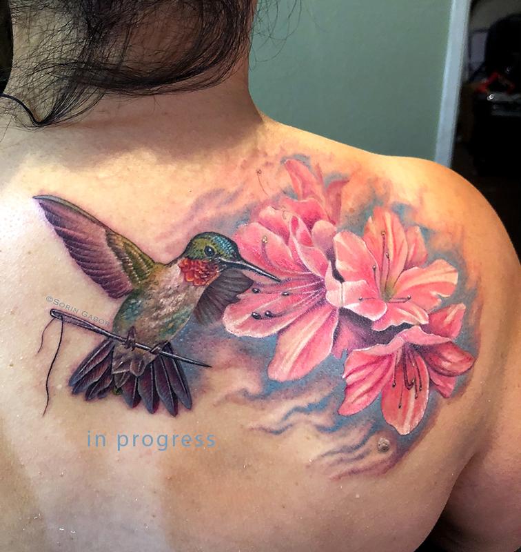 Realistic color humming bird, flower, and sewing needle tattoo