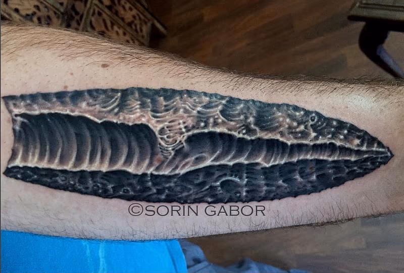 realistic black and gray obsidian tattoo