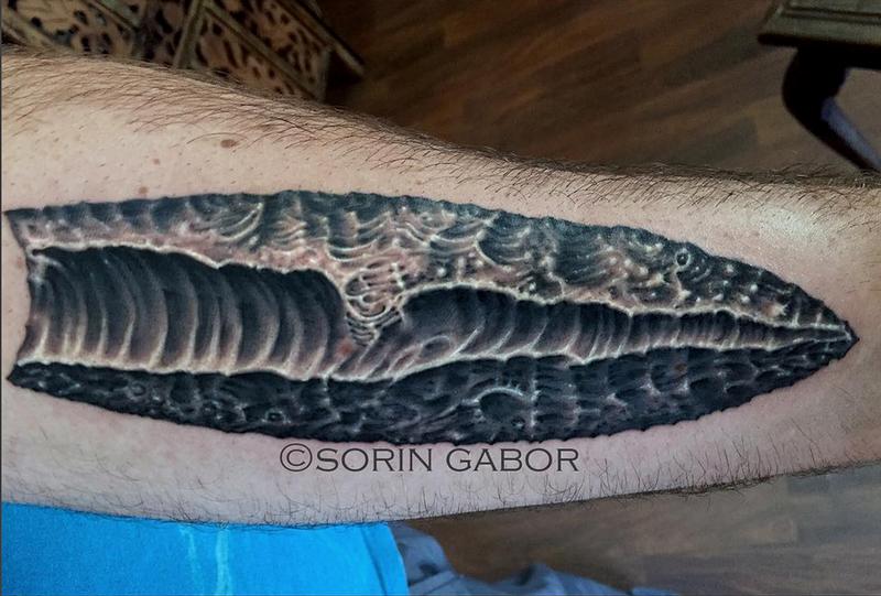 realistic black and gray obsidian tattoo