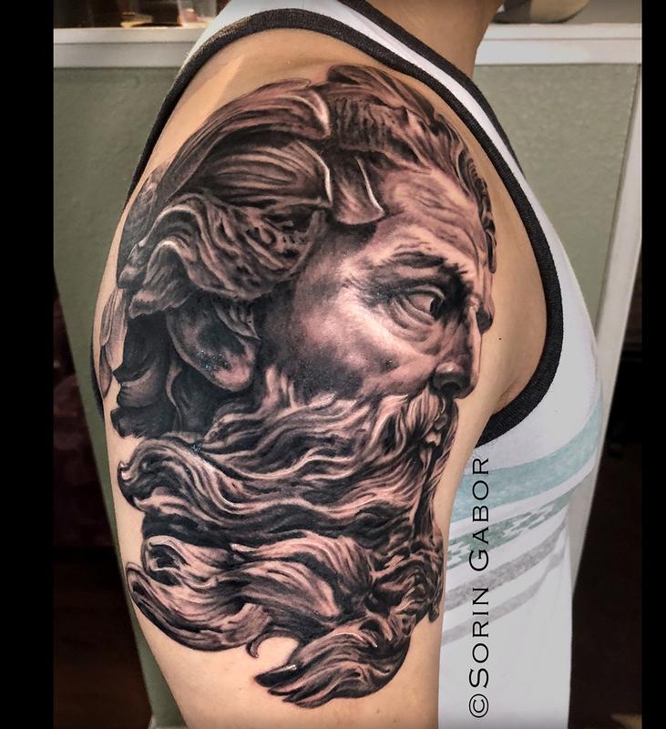 Realistic black and gray Zeus tattoo