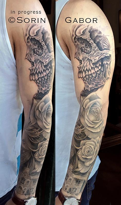 realistic and graphic black and gray sleeve tattoo in progress