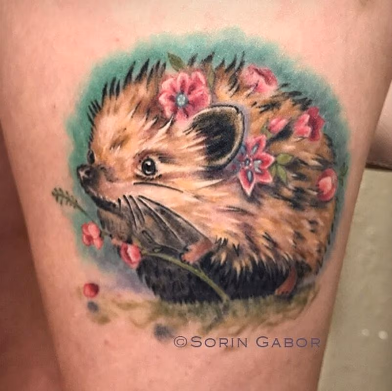 whimsical realistic color feminine hedgehog tattoo with flowers