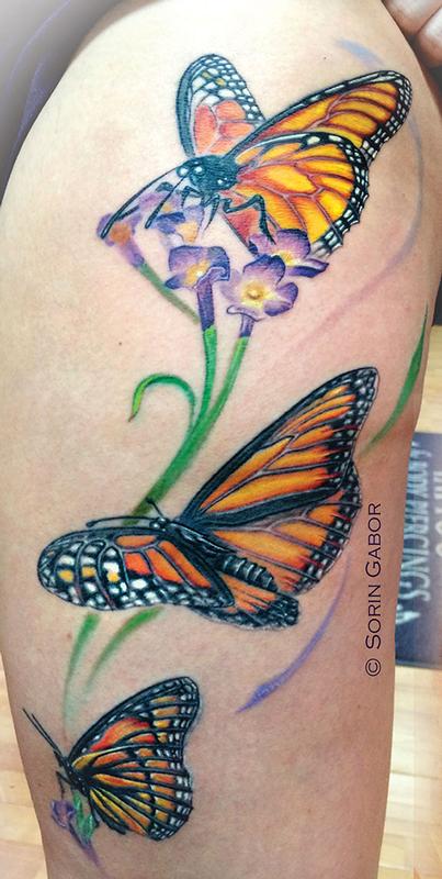 Realistic color monarch butterfly tattoo on thigh