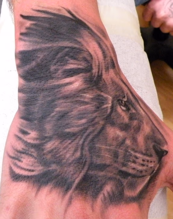 Lion hand tattoo