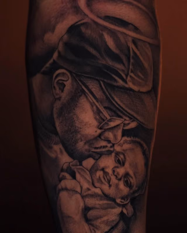 black and grey portrait tattoo of father and child