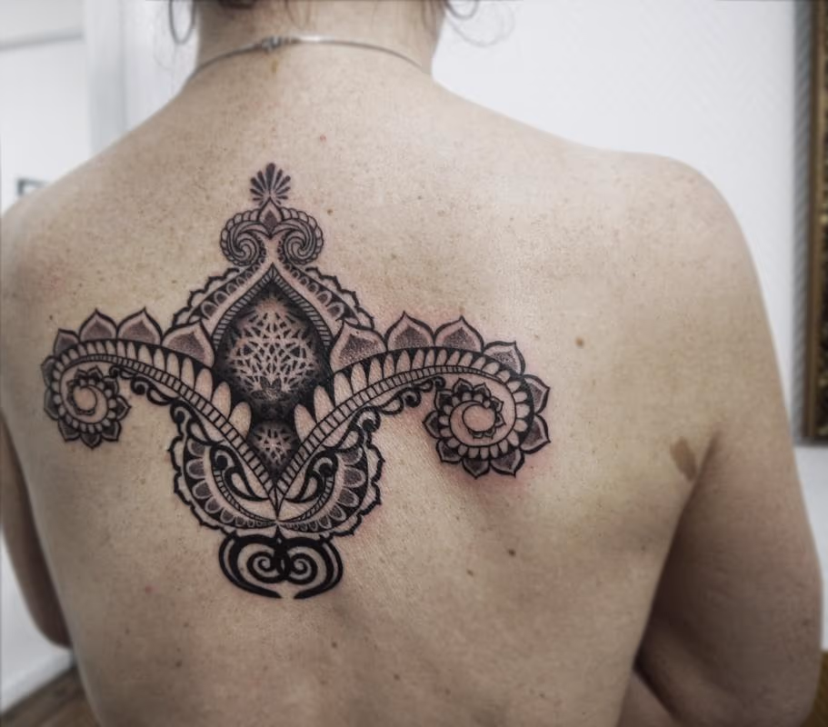 bongo style dotwork linework indian traditional back tattoo