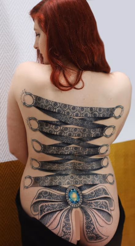 ornamental lace corset backpiece tattoo with crystal centre