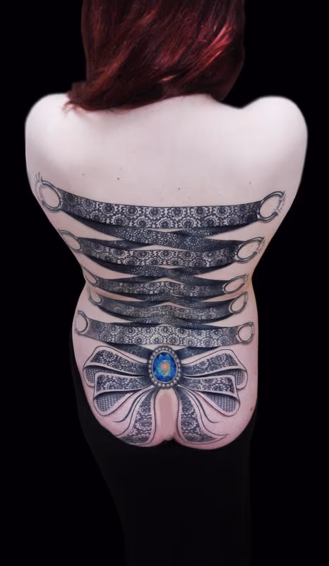 ornamental lace corset backpiece tattoo with crystal centre