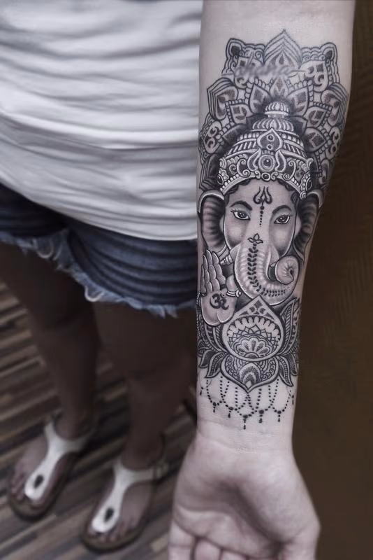 dotwork linework ganesha tattoo with mandala and ornamental lotus