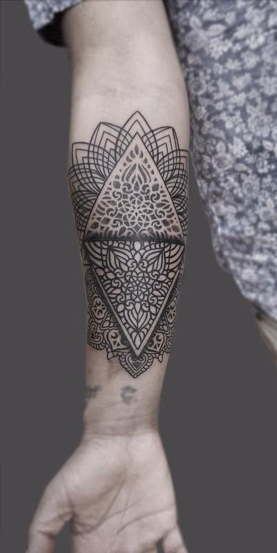 dotwork linework mandala forearm tattoo