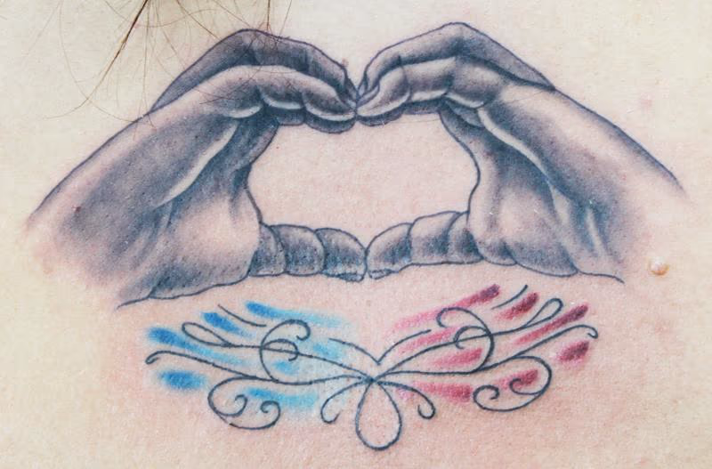 child's hands forming a heart