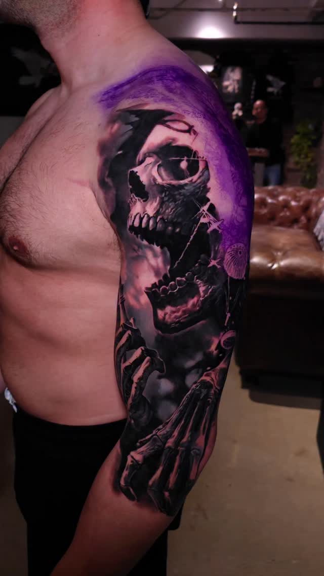 Skull with skeletal hand half-sleeve, black and grey