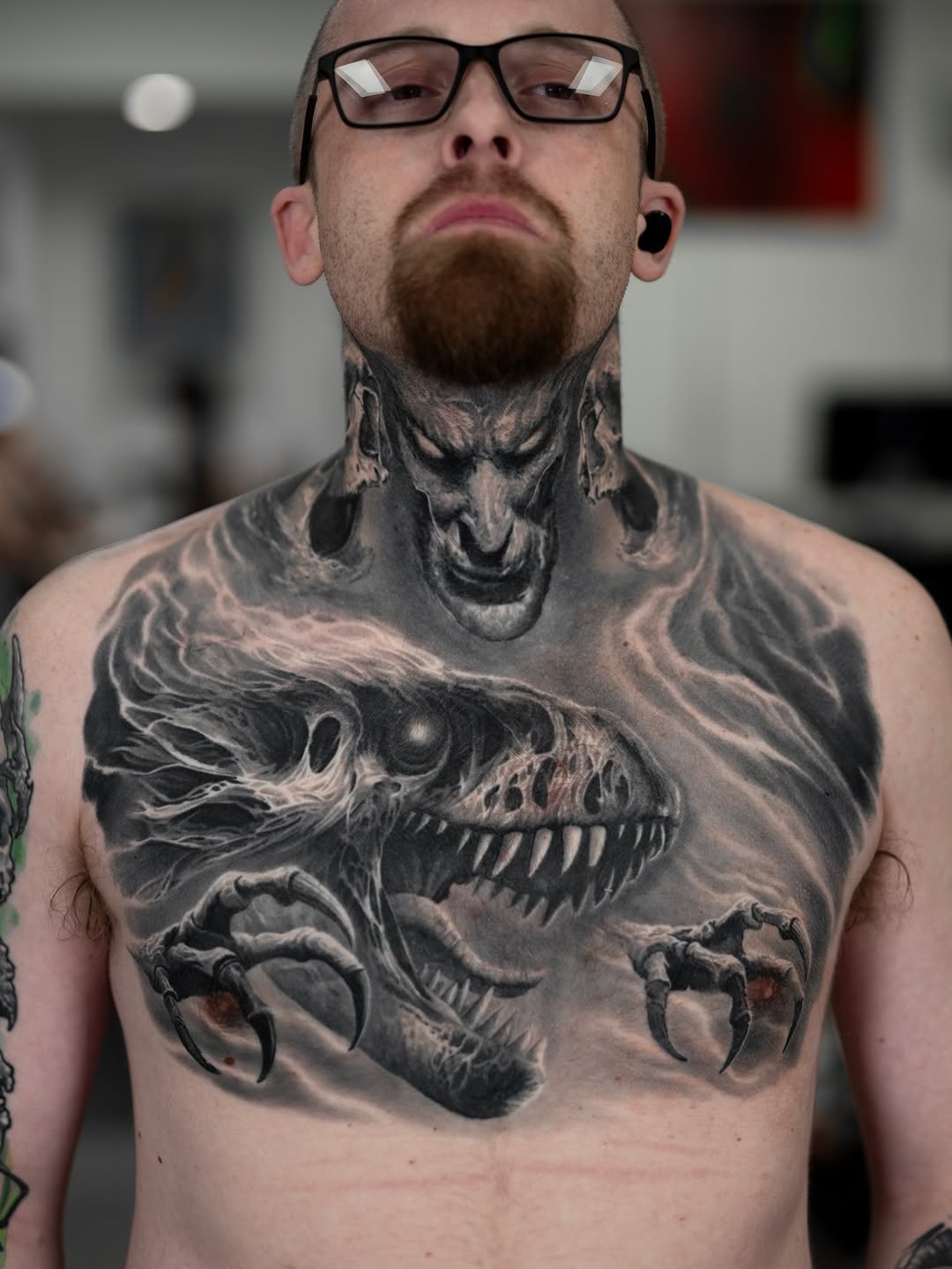 Black-and-grey skulls and monster chest tattoo, realistic