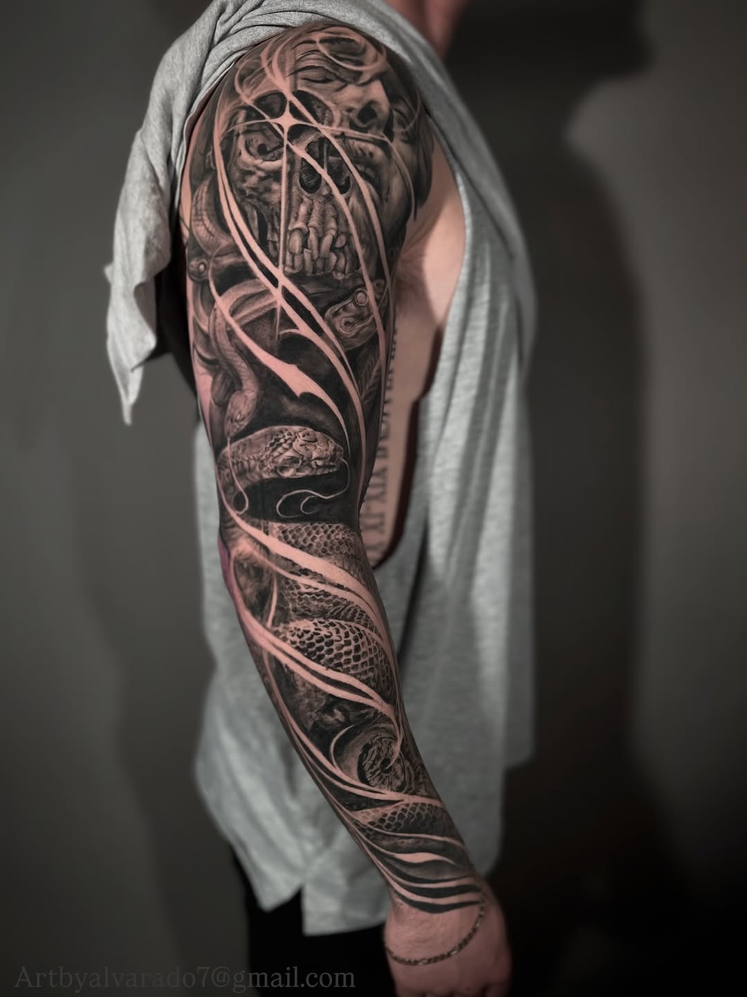 Black-and-grey skull and snake full sleeve