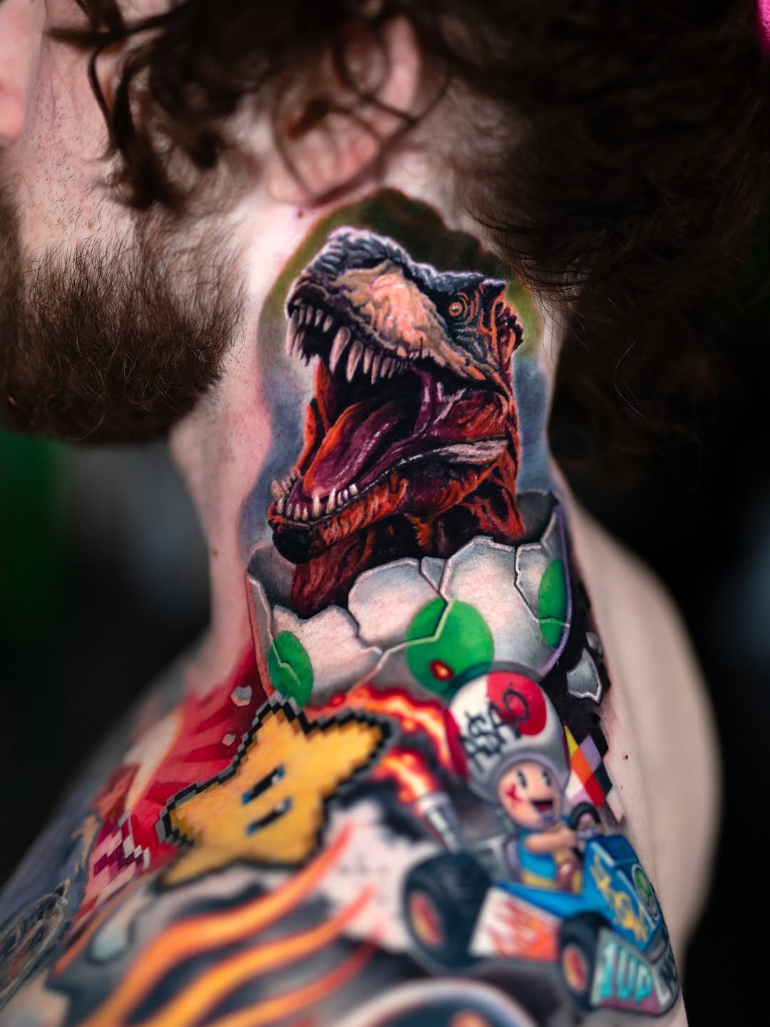 Dinosaur hatching from egg color tattoo, arm