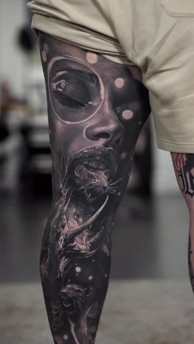 Black-and-grey surreal leg sleeve with portrait and animals