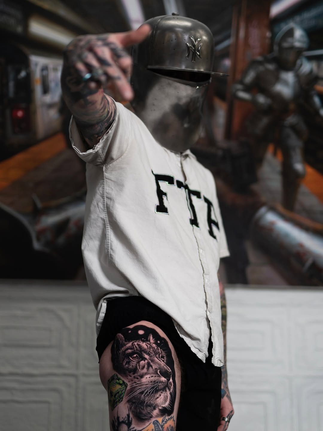 Black-and-grey snow leopard thigh tattoo, NYC